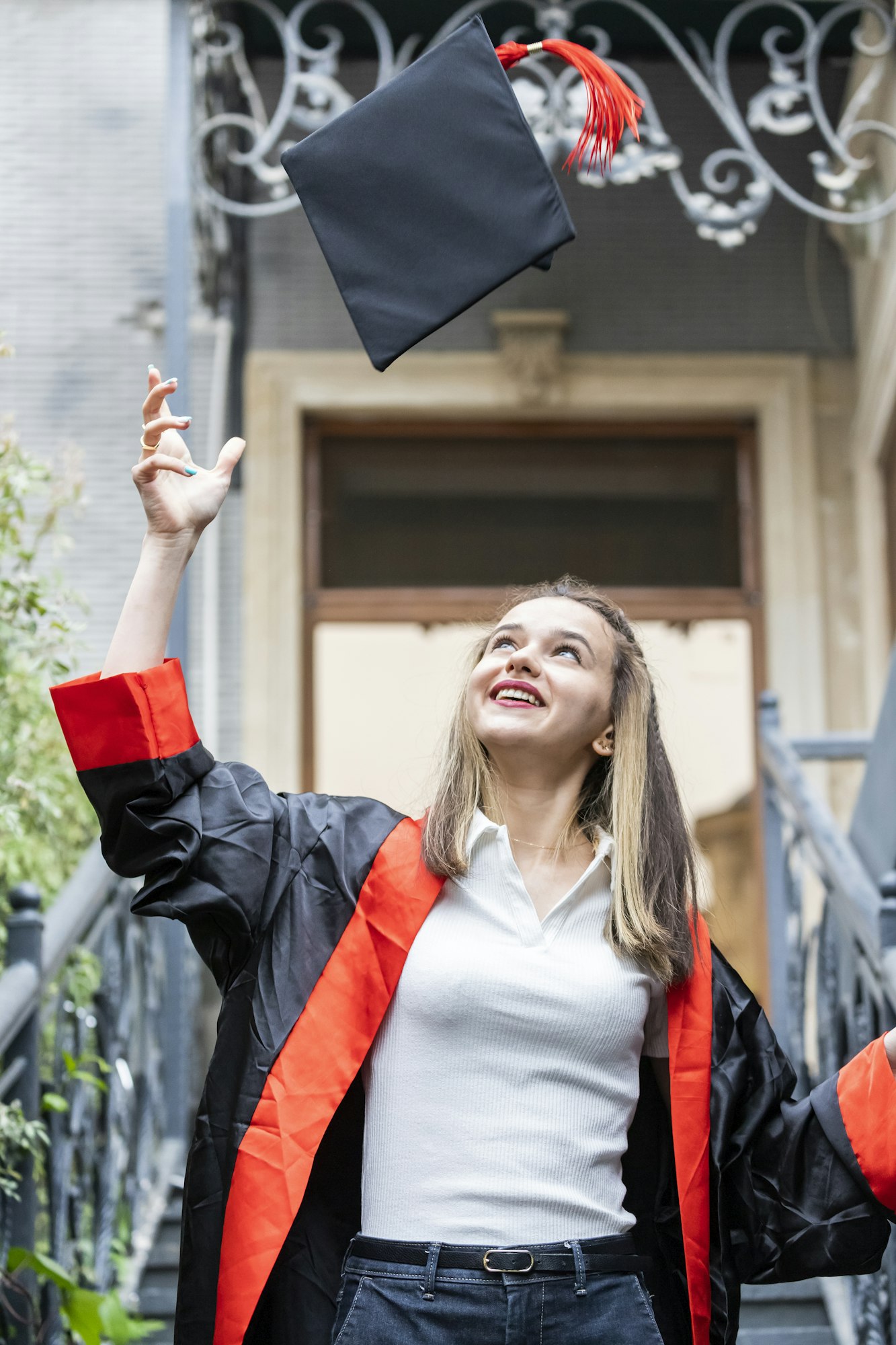 The young student throws up her cap and graduating.